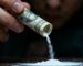 Person preparing to snort cocaine using a rolled banknote.